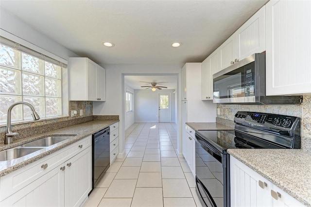 kitchen with sink, white cabinetry, ceiling fan, and black appliances