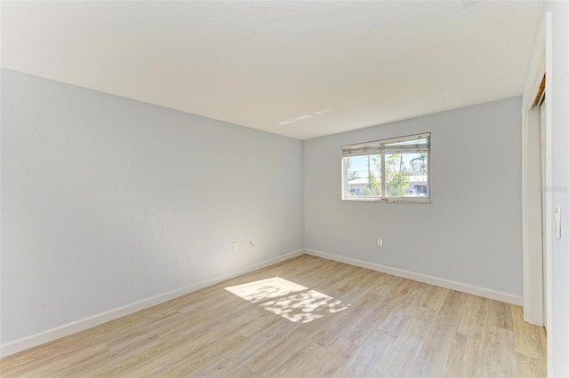 unfurnished room with light hardwood / wood-style flooring