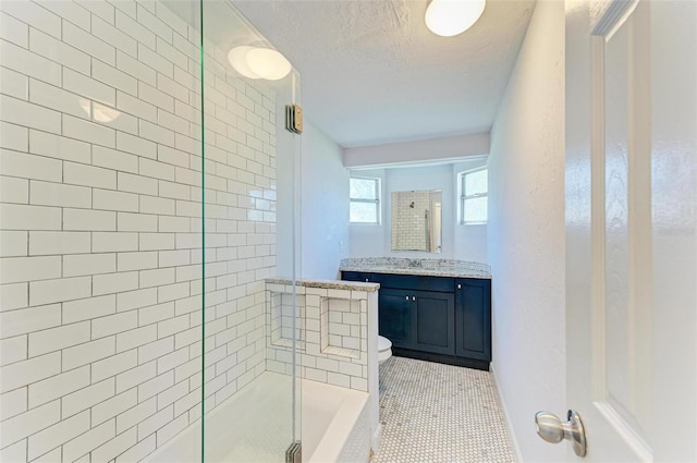 bathroom with tile patterned flooring, a textured ceiling, toilet, vanity, and a shower with shower door