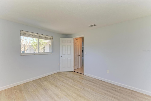 spare room featuring light hardwood / wood-style flooring