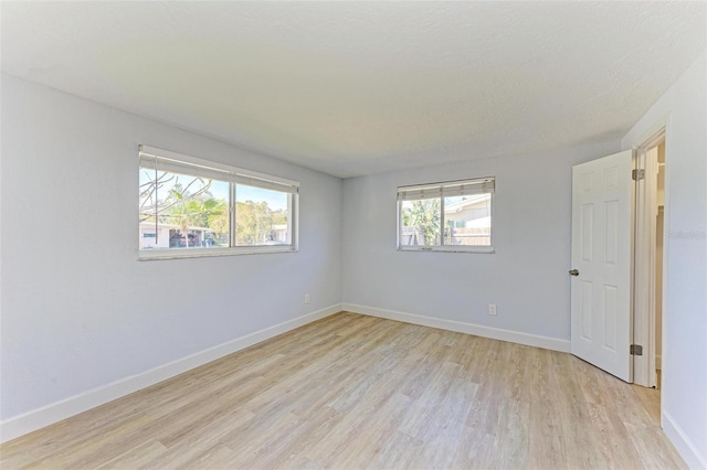 spare room featuring light hardwood / wood-style flooring