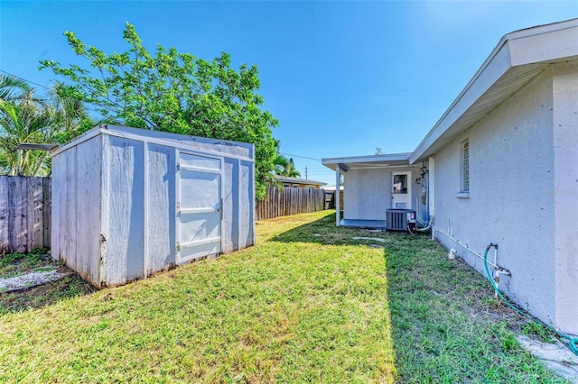 view of yard featuring a shed and cooling unit