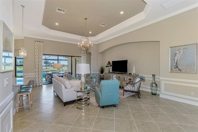 tiled living room with a tray ceiling, an inviting chandelier, and ornamental molding