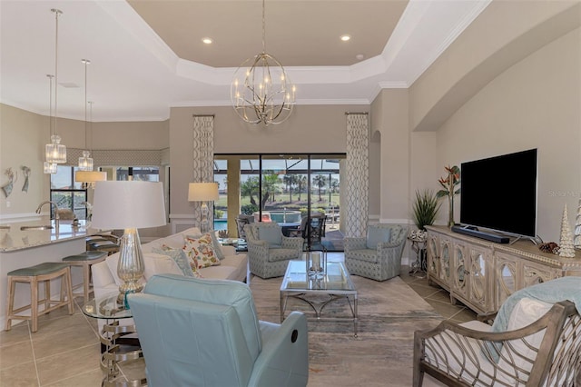 living room featuring sink, a raised ceiling, crown molding, a chandelier, and light tile patterned flooring