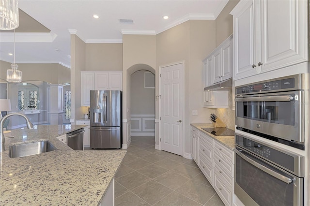 kitchen with light stone countertops, sink, and appliances with stainless steel finishes