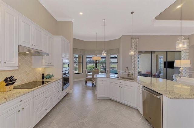 kitchen with white cabinets, appliances with stainless steel finishes, and pendant lighting