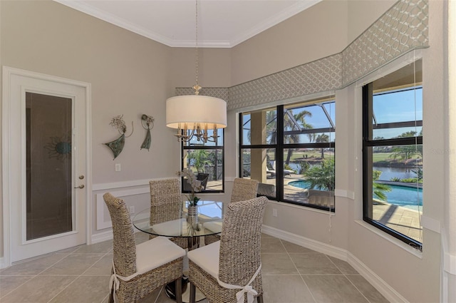 dining space with a healthy amount of sunlight, a water view, light tile patterned floors, and crown molding