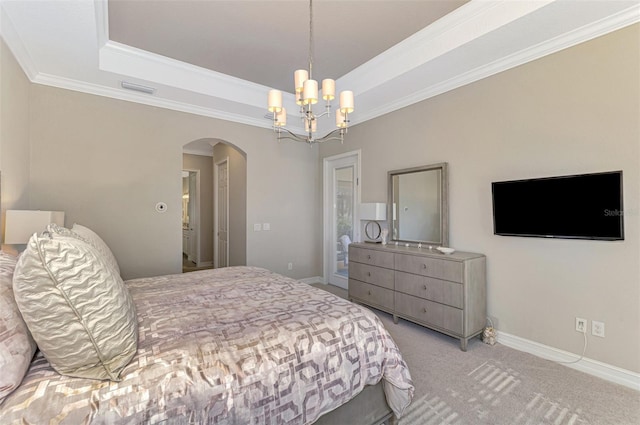 bedroom with ornamental molding, light carpet, a tray ceiling, and a chandelier