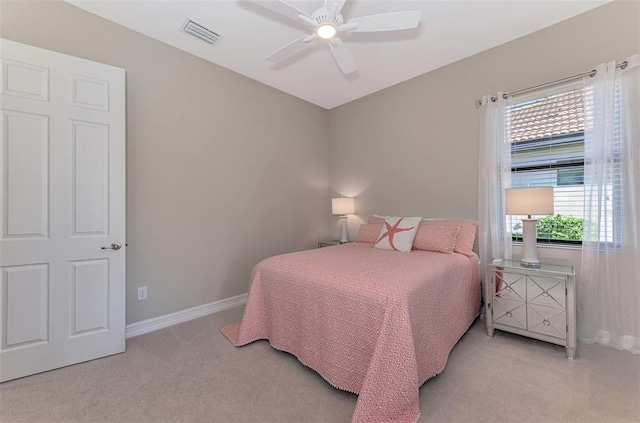 bedroom with ceiling fan and light colored carpet