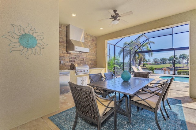 view of patio with area for grilling, ceiling fan, a water view, glass enclosure, and a grill