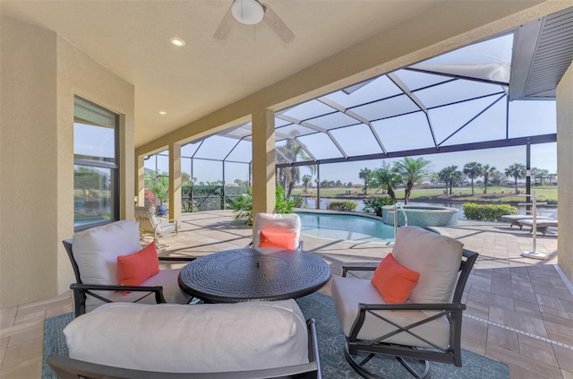 view of patio featuring a swimming pool with hot tub, ceiling fan, and a lanai