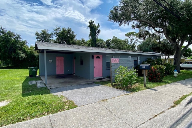 view of front facade featuring a front yard and a carport