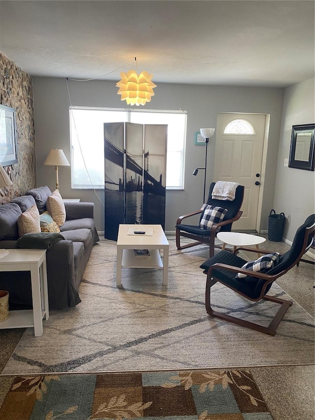 living room featuring carpet flooring and a healthy amount of sunlight