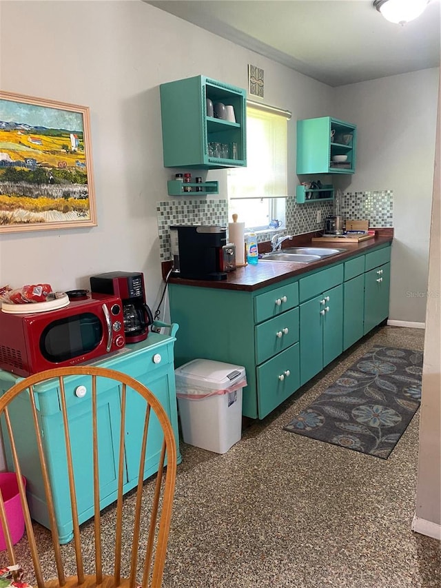 1680 17th St, Sarasota, FL 34234 - kitchen featuring open shelves, backsplash, green cabinetry, and dark countertops