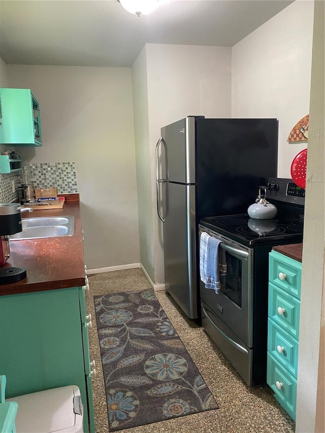 kitchen with appliances with stainless steel finishes, tasteful backsplash, and sink