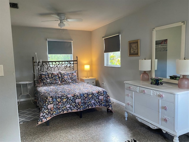 bedroom with a closet, multiple windows, and ceiling fan