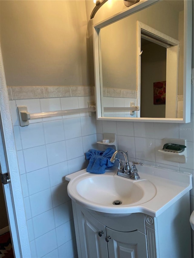 bathroom with vanity and tile walls