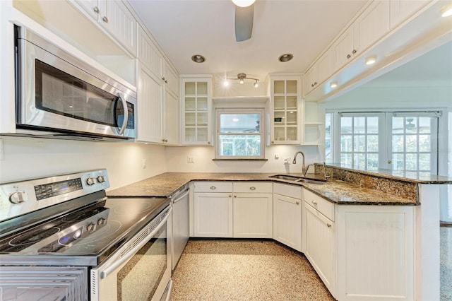 kitchen featuring white cabinetry, sink, french doors, kitchen peninsula, and appliances with stainless steel finishes