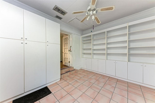 kitchen with ceiling fan, white cabinetry, crown molding, and light tile patterned floors