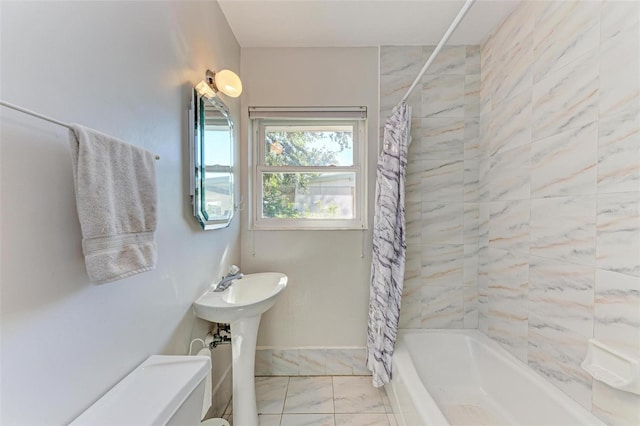 bathroom with shower / bath combination with curtain and toilet