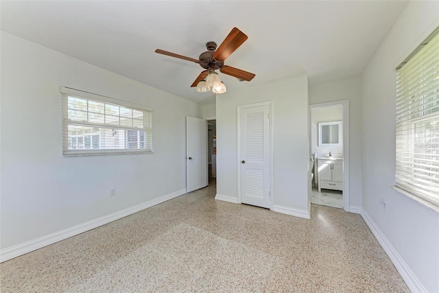 unfurnished bedroom with a closet, multiple windows, and ceiling fan