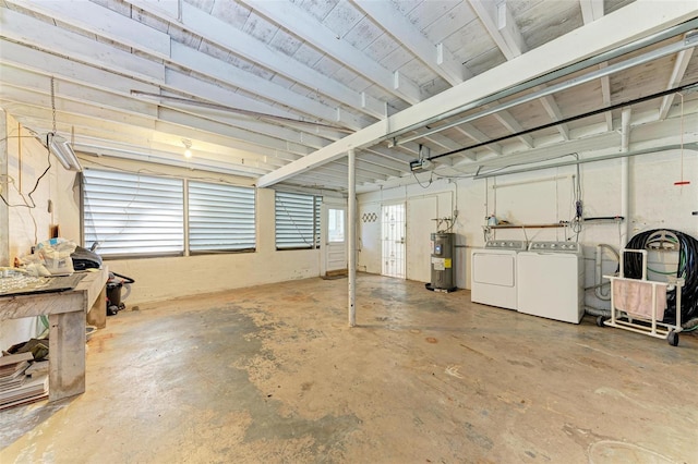 garage with electric water heater, washer and clothes dryer, and a garage door opener