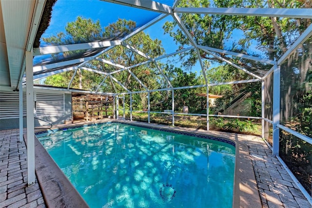 view of pool featuring glass enclosure