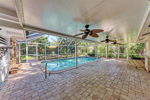 view of swimming pool with a lanai, a patio area, and ceiling fan