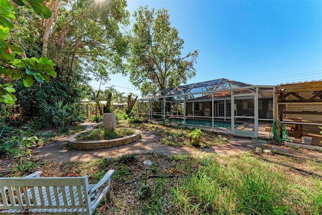 view of yard with glass enclosure