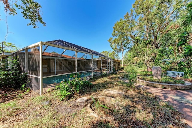 view of yard with glass enclosure