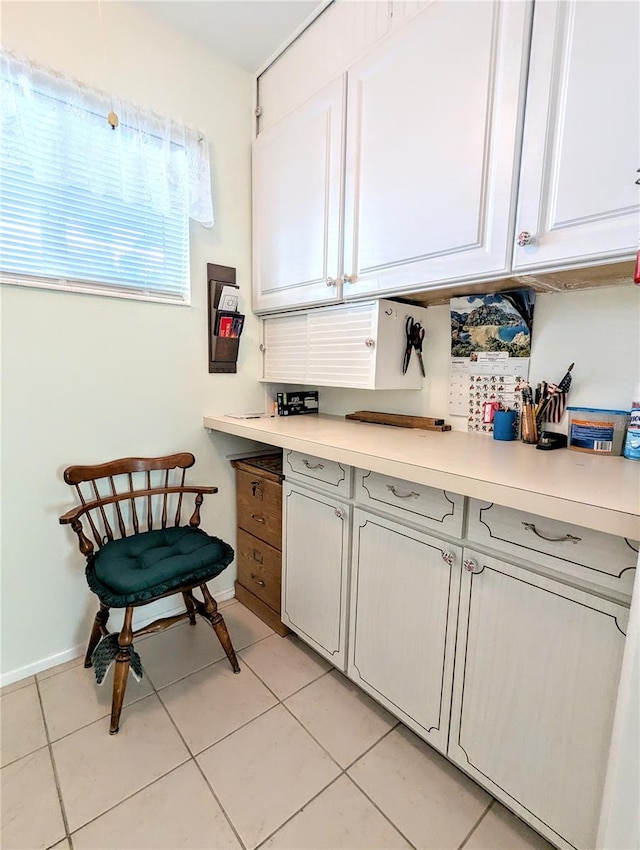 kitchen featuring white cabinets and light tile patterned floors