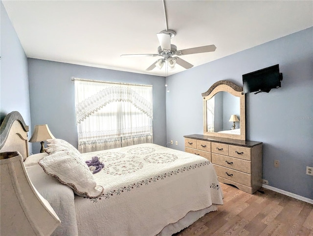 bedroom featuring hardwood / wood-style flooring and ceiling fan