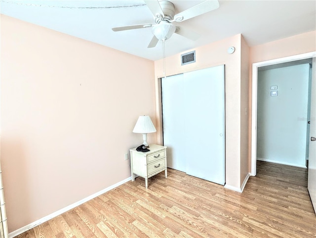 unfurnished bedroom with a closet, ceiling fan, and light hardwood / wood-style flooring