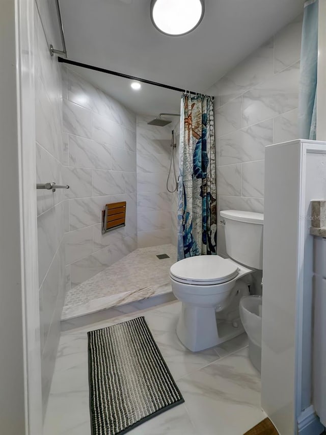 bathroom with a shower with shower curtain, a bidet, toilet, and tile walls