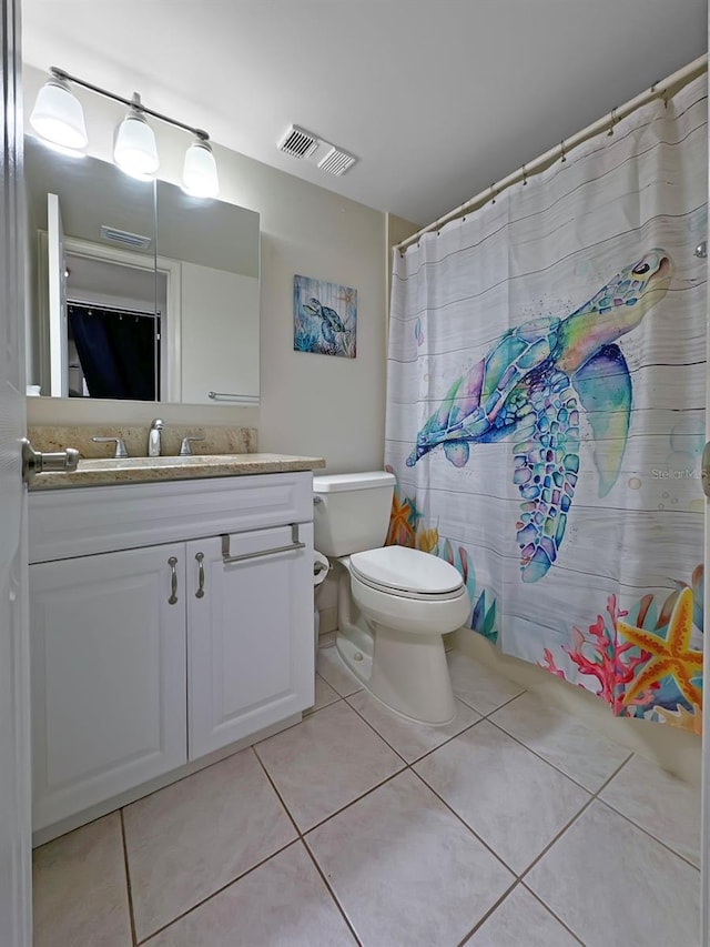 bathroom featuring tile patterned floors, vanity, and toilet