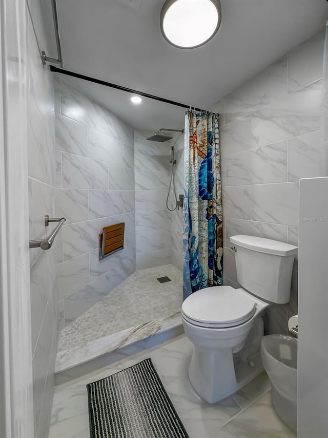 bathroom with a shower with shower curtain, toilet, and tile walls