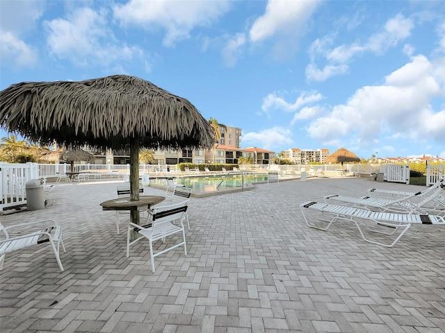 view of home's community featuring fence, a pool, and a patio