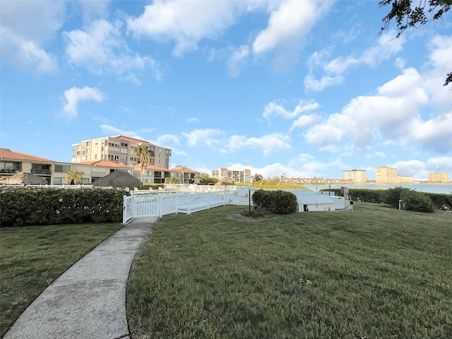 view of yard featuring a view of city, fence, and a pool