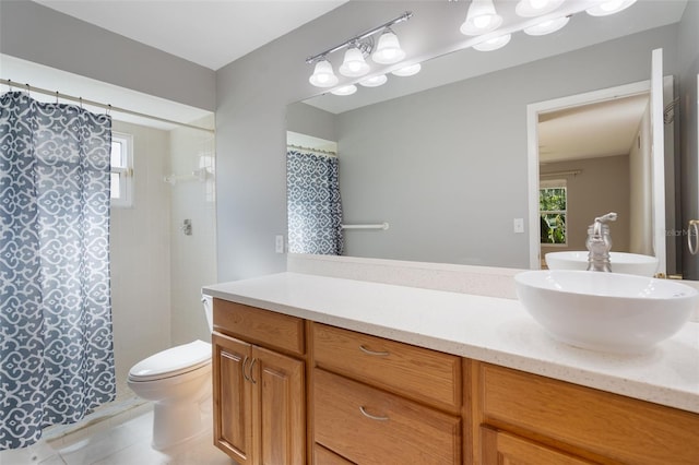 bathroom featuring tile patterned floors, vanity, curtained shower, and toilet