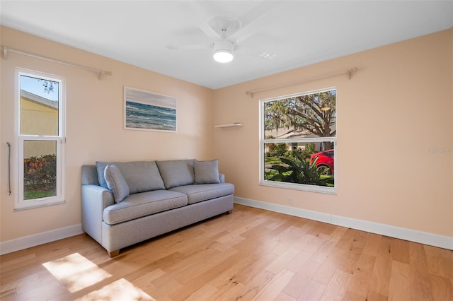 living area featuring ceiling fan and light hardwood / wood-style floors