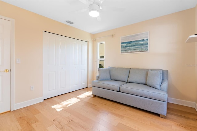 living room with ceiling fan and hardwood / wood-style flooring