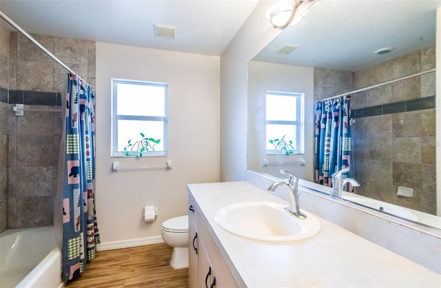 full bathroom with a wealth of natural light, visible vents, wood finished floors, and vanity