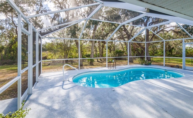 pool with glass enclosure and a patio