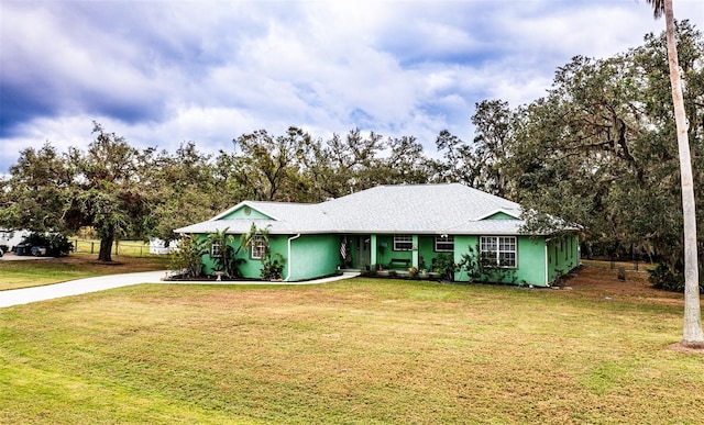 view of front of property with a front yard and stucco siding