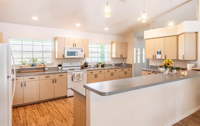 1496 Palm View Rd, Sarasota, FL 34240 - kitchen with white appliances, light brown cabinetry, light wood-type flooring, a peninsula, and pendant lighting