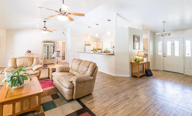 1496 Palm View Rd, Sarasota, FL 34240 - living area featuring lofted ceiling, light wood-type flooring, a chandelier, and a ceiling fan