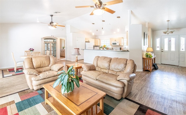 1496 Palm View Rd, Sarasota, FL 34240 - living area featuring a ceiling fan, light wood-style flooring, vaulted ceiling, and a chandelier