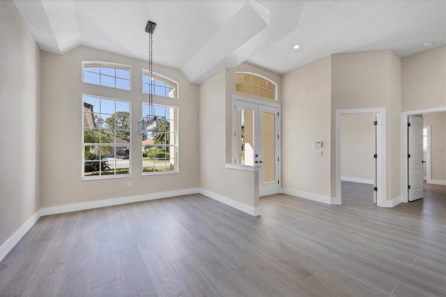 interior space with lofted ceiling and light wood-type flooring