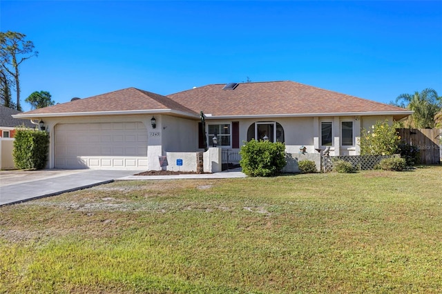 ranch-style house featuring a front lawn and a garage