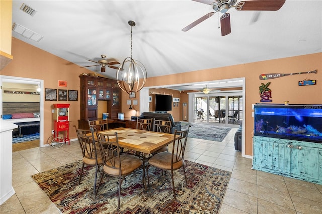 dining room featuring a notable chandelier, light tile patterned flooring, and lofted ceiling